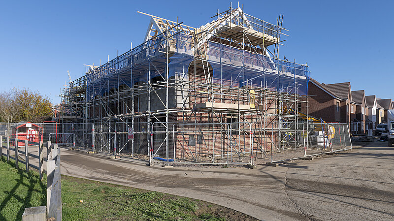 house being built covered in scaffolding 