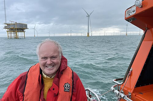 Clive Jones in a boat visiting offshore wind farm