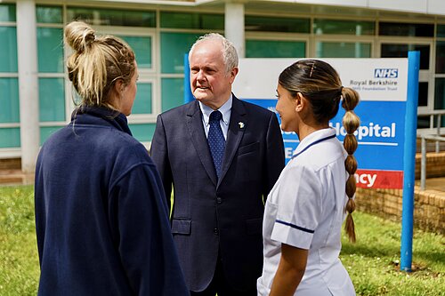 Clive Jones outside the RBH talking to two medical professionals 