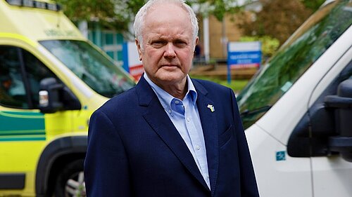 Wokingham's MP, Clive Jones, stood in front of ambulances at Royal Berkshire Hospital