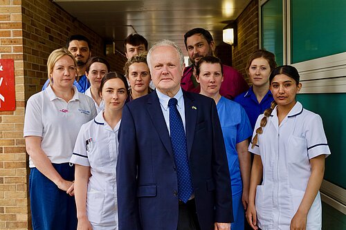 Clive outside the RBH with several medical staff standing behind him