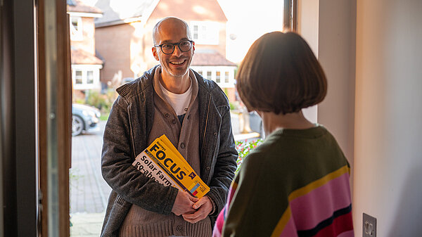 Lib Dem on the doorstep talking with voter