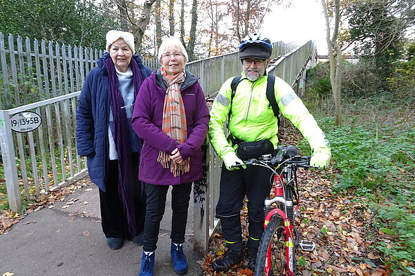 Three of our Woodley Town Councillors, one with a bike, in a park in Woodley