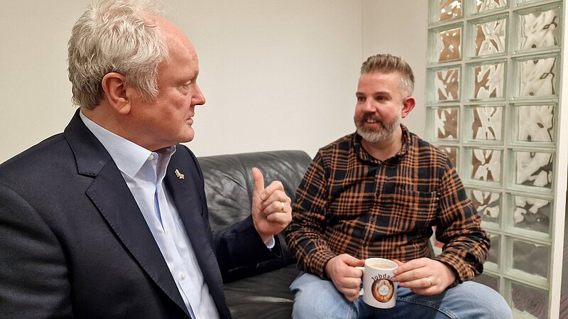 Clive Jones talking with Matt Lincon drinking tea