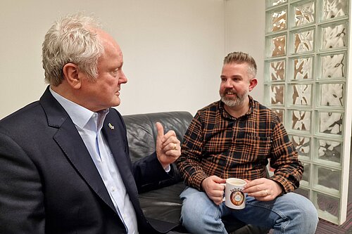 Clive Jones talking with Matt Lincon drinking tea