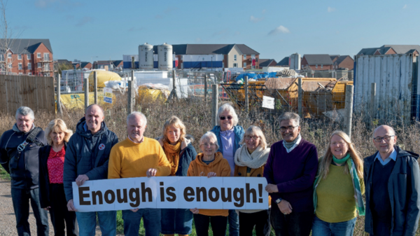Lib Dem campaigners holding a banner against overdevelopment