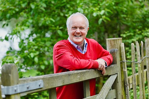 Clive outside by a fence