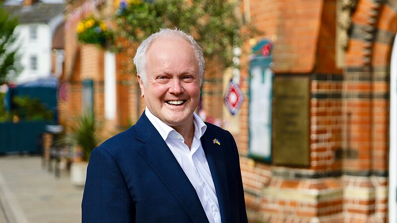 Clive Jones outside Wokingham Town hall, smiling