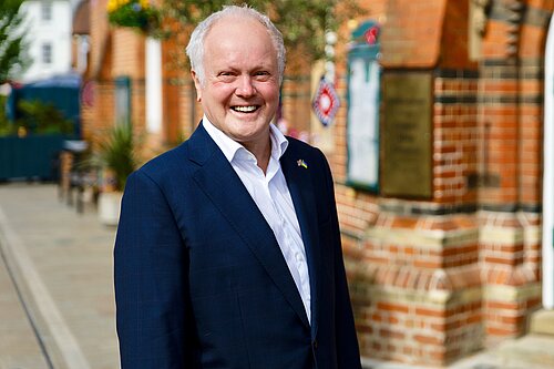 Clive Jones outside Wokingham Town hall, smiling