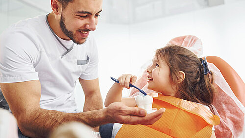 Little girl in dentist chair having a check up.