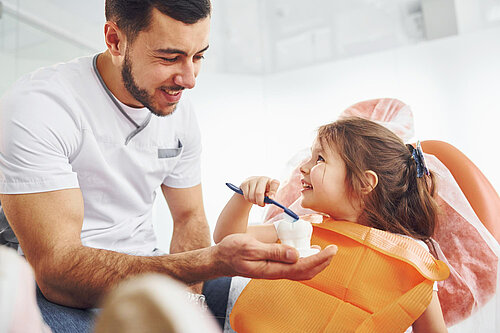 Little girl in dentist chair having a check up.