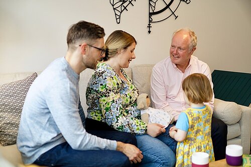 Clive Jones talking to a young family