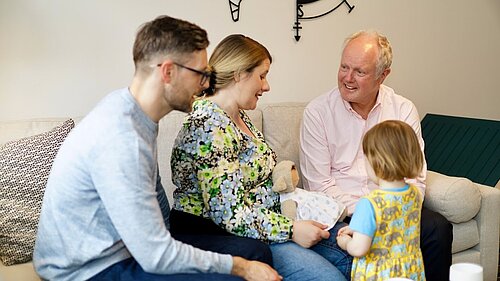 Clive Jones talking to a young family