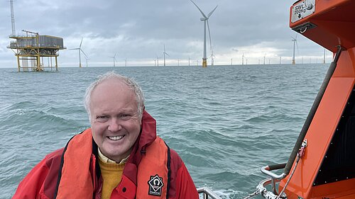 Clive Jones in a boat visiting offshore wind farm
