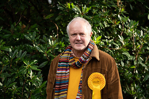 Clive Jones in front of green bushes