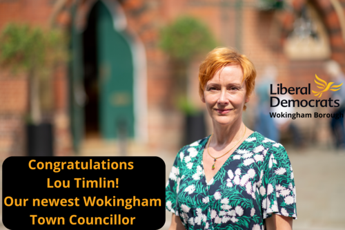 Lou Timlin outside Wokingham Town hall, Lib Dem logo and words "Congratulations Lou Timlin, our newest Wokingham Town Councillor