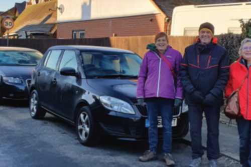 Prue, Paul and Rachelle on a street with tightly packed parked cars